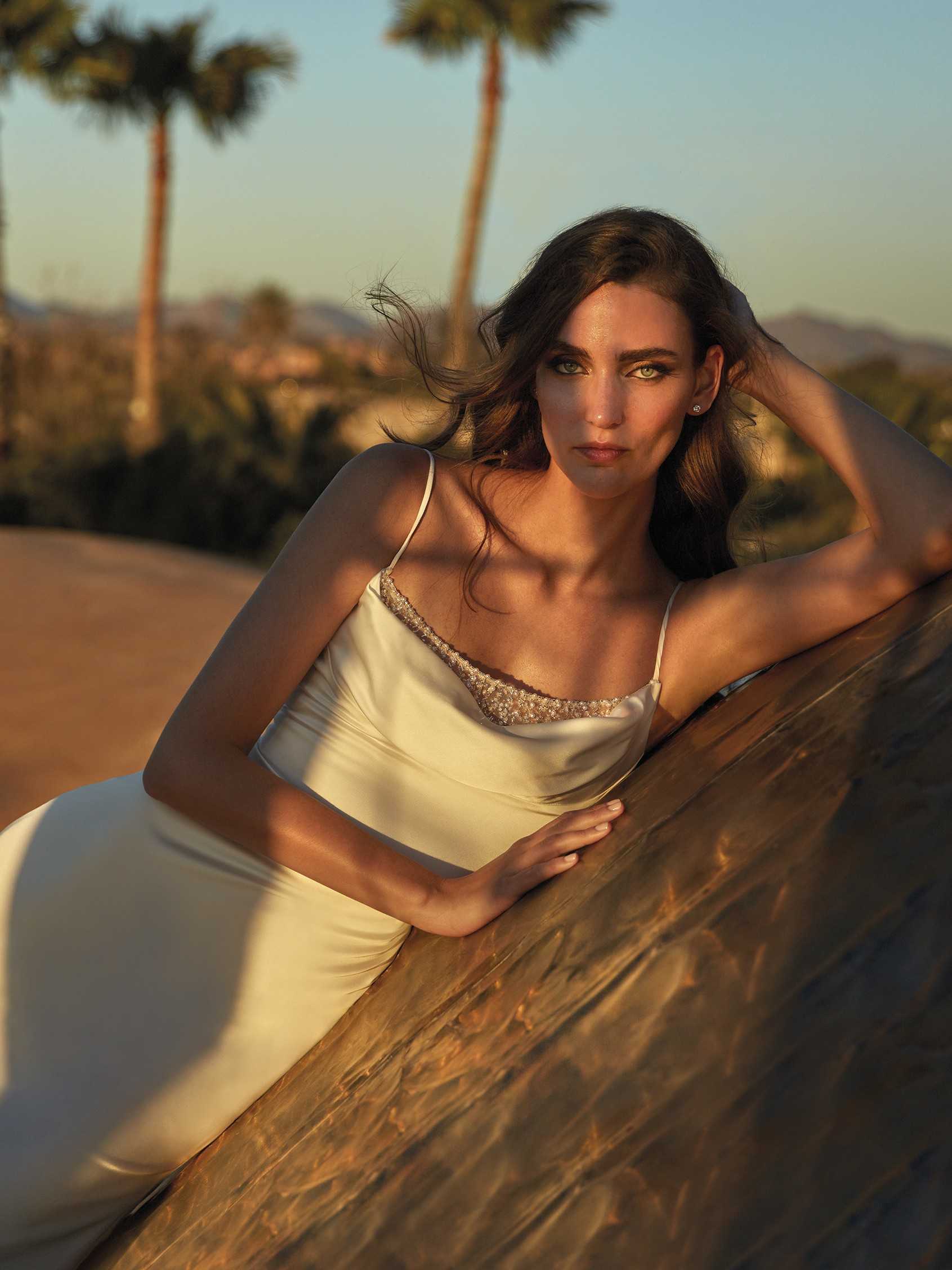 Mujer con segundo vestido de novia sencillo con tirantes y con el pelo suelto.