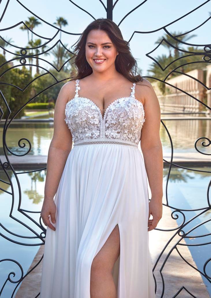 Curvy woman wearing an A-line bohemian wedding dress with beaded lingerie straps and sweetheart neckline