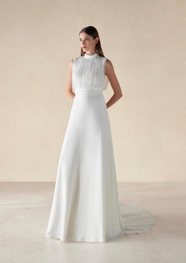 Brunette woman in simple wedding gown with high neckline