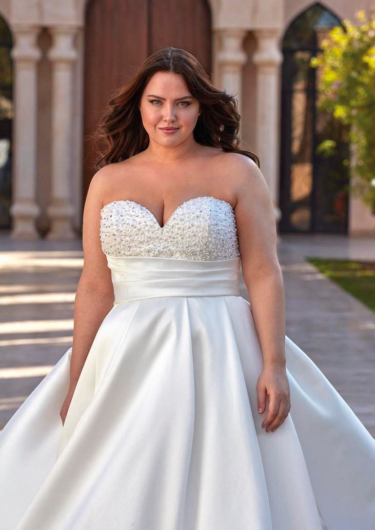 Curvy woman in a Mikado princess-cut wedding gown, featuring a sweetheart neckline and asymmetrical statement sash