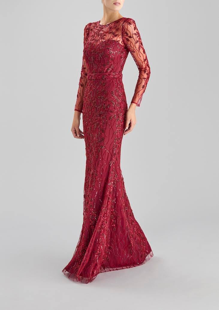Woman wearing a burgungy sheath party dress with long sleeves and bateau neckline and column silhouette