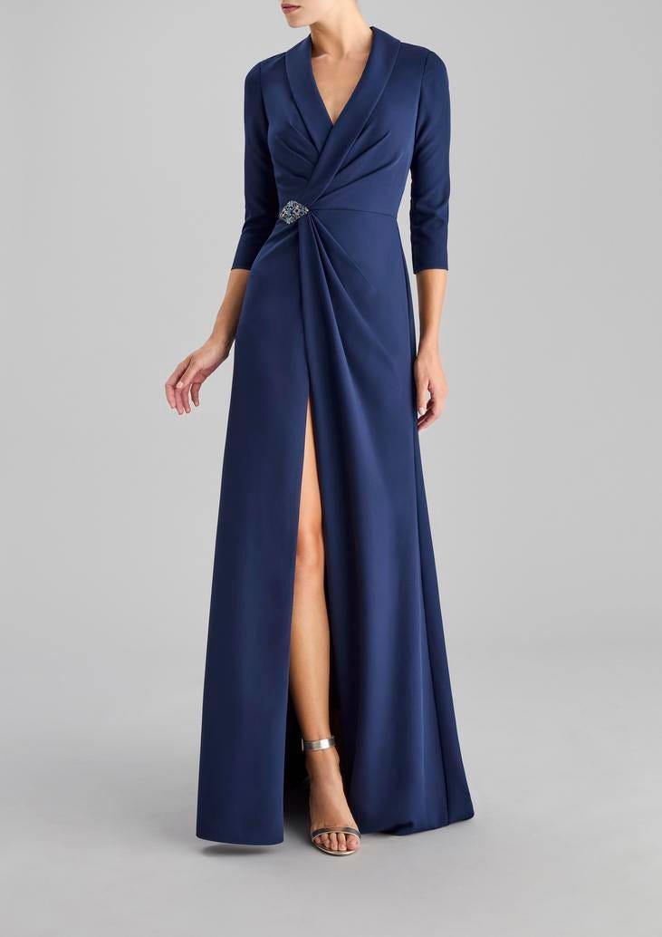 Woman wearing a long A-line crepe party dress in blue with three-quarter sleeves and blazer neckline
