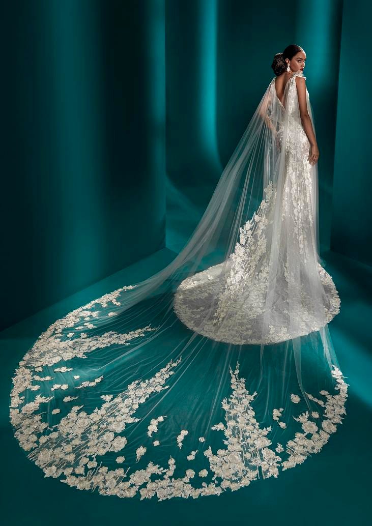 Detachable wedding dress train Woman wearing a bridal gown with lace and flowers, along with a detachable wedding dress train